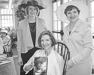 Friends of Youngstown-Mahoning Library recently sponsored an annual tea, where author Erin McGraw, seated, spoke about her book, “Seamstress,” during the program. Taking the opportunity to speak with the author about the book are Joan Wells, left, and Roselyn Gadd. The organization is inviting the public to the Austintown Branch at 10 a.m. May 17 for a presentation by David Frank about the end of the Civil War titled “They March as Though They Were the Lords of the Earth.”