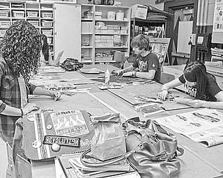Busily creating some of the art to be entered in a two-day art show at Canfield High School are senior students, from left, Melanie Shoenfield, advanced drawing; Caroline Sauer, advanced drawing; and Breland Cockrell, three-dimensional design.