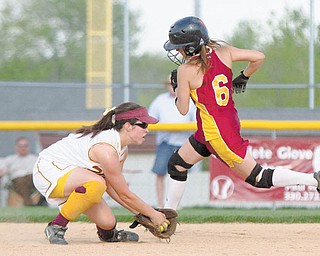 Mooney’s Margo Ucchino makes it past Walsh’s Calia Battista (4) untagged as Battista fi elds a ground ball during the fifth inning of Wednesday’s game at Boardman’s Fields of Dreams.