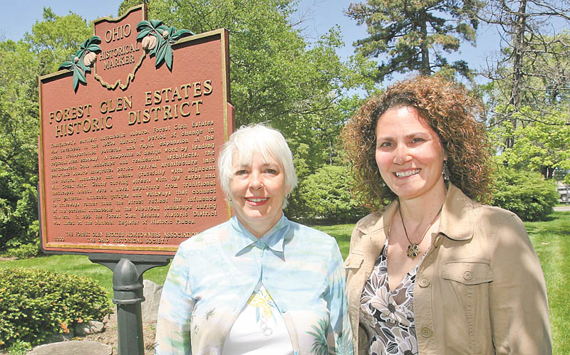 Lynn Kirkwood, left, and Susan Sweeney, vice president and president, respectively, of the Forest Glen Homeowners’ Association, stand next to the marker designating their neighborhood a historic district. Residents of both the Forest Glen and the Newport Glen historic areas expressed worries to Boardman trustees last week about increased crime. The township has a plan to address it and educate all residents about how to protect themselves.