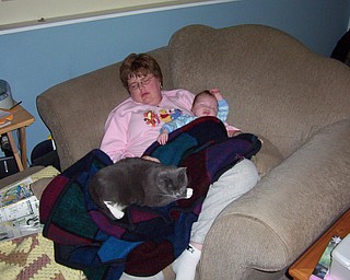 Melanie Shay and her newborn daughter, Abigail, are enjoying a nap with Smokey the cat.
