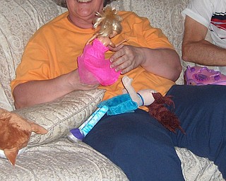 Sandra McKenna of Youngstown is playing dress up with Angela for her birthday.