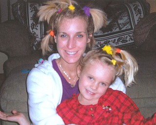 Kim and Erin (7) Chaplow of Canfield had just finished playing "beauty shop" when this picture was taken of their fancy hairdos.