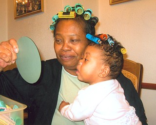 Just for fun, Donna Clayton of Youngstown shared her hair rollers with her granddauhter, Saria Drake of Youngstown.