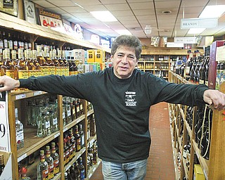 William D. Lewis/ The Vindicator Gino's Drive Thru owner Richie Saul, pixed in the liquor store part of his business.