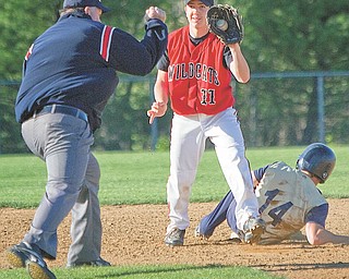 The Vindicator|Geoffrey Hauschild.Struthers' Anthony Lariccia (11) shows his proff after outting Lowellville's Ryan Whinery (14) during the fourth inning of a game at Cene Field on Thursday afternoon.