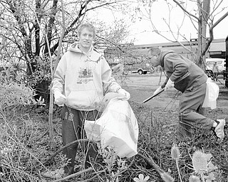 Thirty-one members of Cardinal Mooney National Honor Society and their adviser, Peggy Moore, worked with representatives of Lien Forward Ohio/V&M Star to collect more than 100 bags of trash and recyclables during a recent Youth Day of Caring. Prepared to bag some of the debris, above, Cardinal Mooney High School senior Joe Stoops joins others working during the clean-up day along the West Federal Street corridor near Girard.