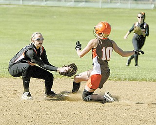 Springfield’s Ashley Davis gets East Palestine’s Emily Stewart (10) out on a steal attempt of second base during
their Division III tournament softball game Monday in East Palestine. Stewart had two hits for the Bulldogs, who
shut out the Tigers, 3-0, and advanced to a sectional final today against Cardinal Mooney.
