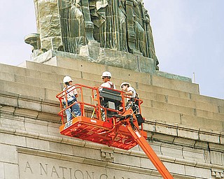 Inspectors from Ameriseal Restoration LLC of Akron and the 4M Co., a Boardman architectural firm, examine the deteriorating facade of the century-old Mahoning County Courthouse in this photo taken in August 2009.