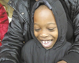Isiah Hill, a second-grader at Jefferson Elementary School, Warren, and his mother, Alma Hill, get ready to release a butterfly at a school assembly.