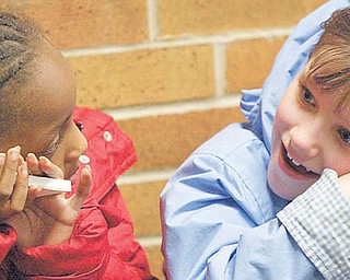 Saria Hurt, left, and Bryanna Criss hold butterfly boxes at the assembly.