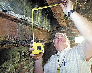William Kostelic, a construction analyst from Poland, examines structural damage inside the Mahoning County Courthouse last June.