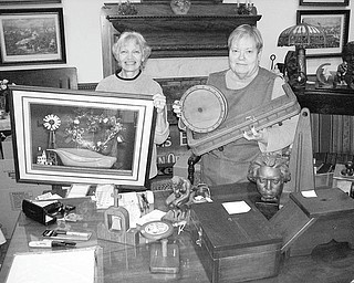 A Rainy Day Yard and Sidewalk Sale has been scheduled for 9 a.m. to 4 p.m. Saturday by Salem Retail Merchants and the East State Street Preservation Association. Busily arranging items to be sold by the Salem Historical Society at the museum, 208 S. Broadway, are, from left, Nancy Fediazko and Virginia Wilms. Some of the books and treasures to be available are from the Dale Shaffer estate.
