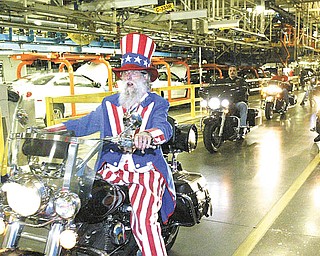 Gary “Bones” Mowen of Niles, dressed as Uncle Sam, leads a group of motorcycles through the GM Lordstown plant Wednesday. More than 50 bikers who work at the plant or are retired took part in the 14th annual UAW GM Lordstown Bike Show. The event raised money for the March of Dimes.