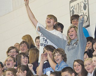Eighth-graders Hailey Scoville, left, and Melissa Sawman stand and scream during the assembly, which took place at the school Wednesday.