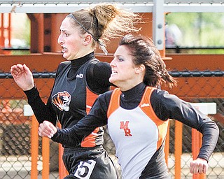 Seniors Sara Montgomery of Springfi eld, back, and Kristen Basista of Mineral Ridge run neck-and-neck in the 100-meter dash during the ITCL Championship track meet Thursday at Springfi eld High School. Basista came in second to Montgomery, but she was named girls MVP.