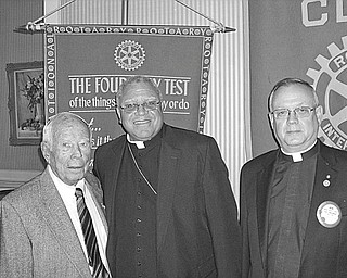 The Paul Harris Fellow award was presented to Bishop George V. Murry during the April 28 meeting of Youngstown Rotary Club. The award was presented to Bishop Murry in appreciation of his work with Catholic Charities in feeding the poor in the community and in poor countries and for his assistance in building friendly relations among the people of the world. Sharing the moment with Bishop Murry, center, are from left, Dr. Bo Edwards, Rotarian, and Monsignor Robert Sifrin, Rotarian and former club president.