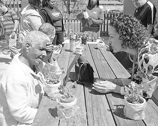 “Spring Fling,” a collaborative event sponsored by Gateways Industries Day Habilitation Center and No Limits Day Habilitation Center, was a celebration of sunshine, new growth and friendship for people with disabilities. Shown with the pots they decorated, personalized and filled with flowers are a few of the guests at the outdoor event. Music was provided by Dan Kalavsky.