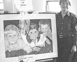Artists at the Senior Independence Senior Center of Mahoning County, 1110 Fifth Ave., Youngstown, exhibited their works during an art show April 13 and 14 at the center. Brigitta Hanzely, above, displays her painting that earned the Best of Show award. Other winners were Mary Pinter, J. Harris, Ethel Nelson, Stella Ziegler, Judy Ours, Eugene Bennett, Sonny Lazar, Pete Balaban, Joe Alessi, A. Craig, P. Zelinski, B. Anderson, Dorothy Lesko, P. Richards, J. Rogers, and R. Bonis. The artists were honored at a reception on April 16.