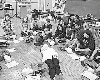 Each year students in eighth-grade at St. Patrick School in Hubbard learn CPR and how to use an automatic electrical defibrillator in order to save lives. A demonstration of the life-saving techniques, taught by Joan Humphry, registered nurse, held the attention of the students above who will receive certification cards through the American Heart Association Heartsaver AED program.