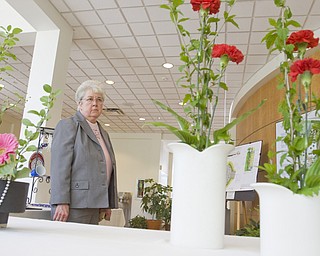 LISA-ANN ISHIHARA | THE VINDICATOR..Sister Mary Cunningham of Youngstown looks at the floral arrangements at the Garden Forum Spring Flower show inside Fellow Riverside Gardens.