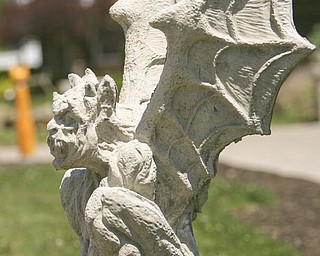 ROBERT K. YOSAY | THE VINDICATOR..A gargoyle stands guard over the numerous yard decorations at Farmer Dave's Gift and Garden shop in North Lima -- 30-