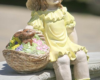 ROBERT K. YOSAY | THE VINDICATOR...Hand painted by the owner Arleen (ok) Fitzer a litttle girl basket in hand sits on a bench at Farmer Dave's Gift and Garden Shoppe in North Lima -- 30-