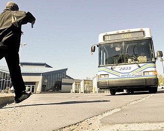 A rider hurries to board a WRTA bus in downtown Youngstown.