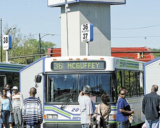 Riders wait to board a bus at the Western Reserve Transit Authority at its station in downtown Youngstown. Some have criticized WRTA for allowing the downtown terminal to deteriorate as it spends $1.2 million to expand its administrative offices.