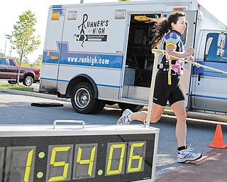 Marisa Facchini crosses the finish line after competing the triathlon at the YMCA in Boardman..
