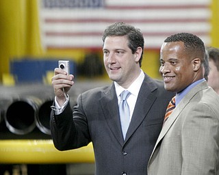William D Lewis| The Vindicator  Tim Ryan snaps a photo while Jay Williams looks on during 5-1810 visit tio VM Star Steel by Preside3nt Obama.