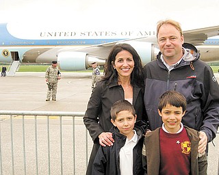  A steel barrier seperates Joe and Judy Kordupel of Boardman, their son Joey, right, and nephew Noah Pecchia, left, from Air Force One along the tarmac at the Youngstown Air Reseve Station in Vienna. The family eagerly awaited a tour on the airplane that brought President Barak Obama to the region to discuss the economy and the V and M Star expansion. Photo by Doug Livingston.