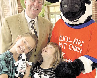 William D. Lewis | The Vindicator Poland North Elem 2nd graders Kaylee Hrusovski, left, and Christin Murcko share a moment at their school 5-19-10.Christin Murcko, who has down syndrome, and Kaylee Hrusovski, who has been somewhat of a student mentor to Christin. Principal Mike Masuci said these two students were included in the schoolÕs application for the Chikfil a Core Essentials Award..They are with Boardman Chik fil a operator Gail McCullough who presented the school with a check for $500...