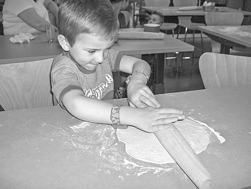 Tom and Jill Zidian invited students from Holy Family Preschool and their teacher, Johnna Lewis, to a Mother’s Day event at their new Culinary Arts Center, 492 McClurg Road, Boardman, where the youngsters had an opportunity to become chefs for the day. Among those who joined their mothers in making pizza from scratch was Andrew Kali, 4, above, who found rolling pizza dough was a fine art.