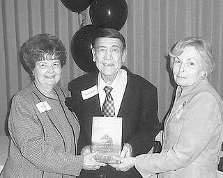 During a recent meeting of Mahoning County Retired Teachers Association at Antone’s Banquet Center, Boardman, deceased members were eulogized for their service to the community. In their memory a book, “On Hallowed Ground,” by Robert Poole, was presented to Youngstown Public Library to become part of the permanent collection on behalf of the John M. Knapick Memorial. Participating in the ceremonial presentation were, from left, Sally and Edward Winsen and Dorothy Burke, MRTA president.