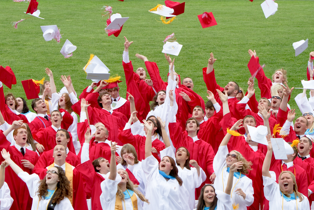 Geoffrey Hauschild|The Vindicator.Graduates throw their caps into the air during Columbiana High School's 2010 Commencement Ceremony at Firestone Park on Sunday afternoon.