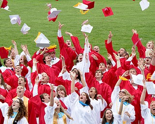 Geoffrey Hauschild|The Vindicator.Graduates throw their caps into the air during Columbiana High School's 2010 Commencement Ceremony at Firestone Park on Sunday afternoon.