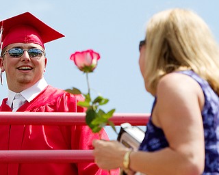 Geoffrey Hauschild|The Vindicator.Graduate, Michael McMaster, presents his mother, Carrie McMaster, during Columbiana High School's 2010 Commencement Ceremony at Firestone Park on Sunday afternoon.