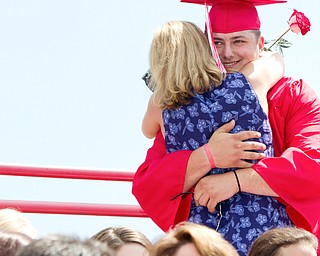 Geoffrey Hauschild|The Vindicator.Graduate, Michael McMaster, gets a hug after presenting his mother, Carrie McMaster, with a flower during Columbiana High School's 2010 Commencement Ceremony at Firestone Park on Sunday afternoon.