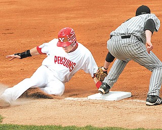 Youngstown State’s Jacke Healy, left, steals third base during the first inning of a Horizon League game against Wisconsin-Milwaukee on April 23 at Eastwood Field. Milwaukee’s Doug Dekoning is late with the tag. The Penguins play UIC in the Horizon League tournament on Wednesday at 4 p.m.