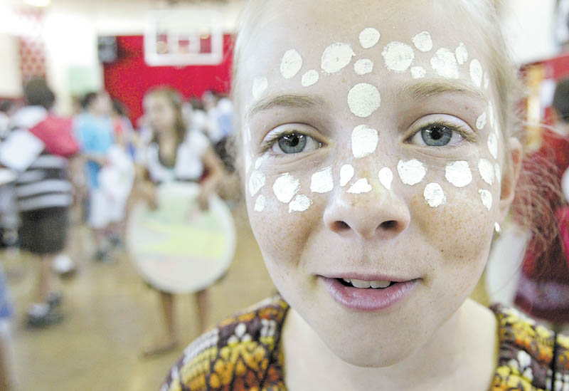 Columbiana sixth-grader Madelyn Kimpel, above, displays face-painting of the style worn by women in Ethiopia during a “Country Extravaganza” on Tuesday at South Side Middle School. Sixth-grade students did more than just study various countries; they donned the attire worn there.
