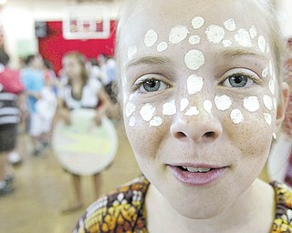 Columbiana sixth-grader Madelyn Kimpel, above, displays face-painting of the style worn by women in Ethiopia during a “Country Extravaganza” on Tuesday at South Side Middle School. Sixth-grade students did more than just study various countries; they donned the attire worn there.