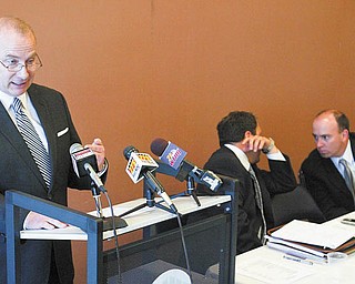 John B. Reardon, left, former Mahoning County treasurer, speaks to reporters at a news conference at the Covelli Centre concerning the county’s purchase of Oakhill Renaissance Place as county Auditor Michael V. Sciortino, center, and Commissioner John A. McNally IV confer. Reardon, Sciortino and McNally said Tuesday that mounting Oakhill-related bills have substantiated their objections to the purchase.