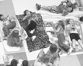 The weather may not have been balmy, but pupils at Struthers Elementary School braved the elements the week of May 10 as they celebrated Right to Read Week with a beach theme. Children in kindergarten through fourth grade participated in several literacy activities and joined in the beach theme by wearing beach hats, visors, sunglasses and T-shirts that could be read and lying on beach towels to enjoy reading some of their favorite books. Each class also enjoyed a guest reader from the community as well as “mystery readers” from Struthers Middle School.