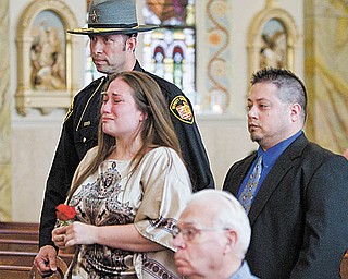 Mahoning County Deputy Sheriff John Marenkovic escorts Marisa Litch of Struthers at the ceremony. Behind them is her brother Bobby Litch of Campbell. Their father, John ÒSonnyÓ Litch of the sheriff Õs department, was shot and killed Oct. 22, 1981.