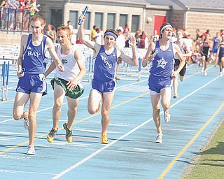 Poland senior Sean Murphy, third from left, and Lakeview senior Albert Brannan, right, cross the fi nish line Thursday afternoon in the 4x800-meter relay at the Division II regional meet in Ravenna. Poland was third and Lakeview fourth behind Bay Village Bay and Elyria Catholic.