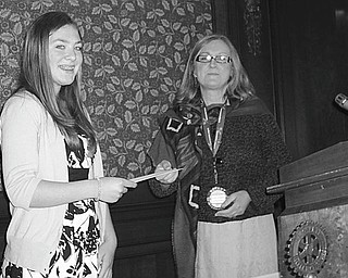 Julia Miglets, left, who won the Rotary Club of Youngstown’s spelling bee recently, received a $100 savings bond from Mary Womble, Rotary president, at the club’s May 12 meeting.