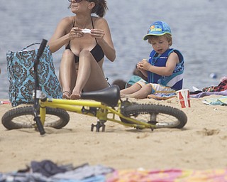 LISA-ANN ISHIHARA | THE VINDICATOR..Melissa Contestabile of Vienna and Kealan Kelley (3) of Nelson (owner's son) have a bite to eat during day one of Jonesfest at Nelson Ledges Quarry Park.