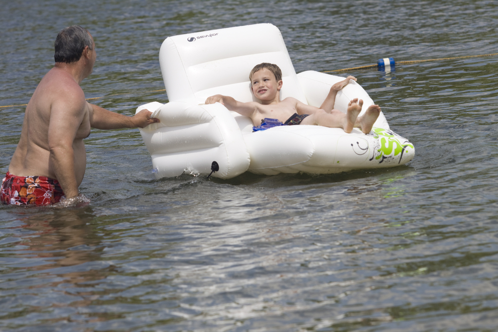 LISA-ANN ISHIHARA | THE VINDICATOR..Richard Wilkinson of Wingham and his grandson Jeffrey Byrd (7) of .Willoughby Hills hang out in the lake during day one of Jonesfest at Nelson Ledges Quarry Park.