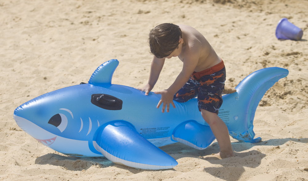 LISA-ANN ISHIHARA | THE VINDICATOR..Kaiden Jewell (4) of Hudson hangs out with his inflatable shark during day one of Jonesfest at Nelson Ledges Quarry Park.